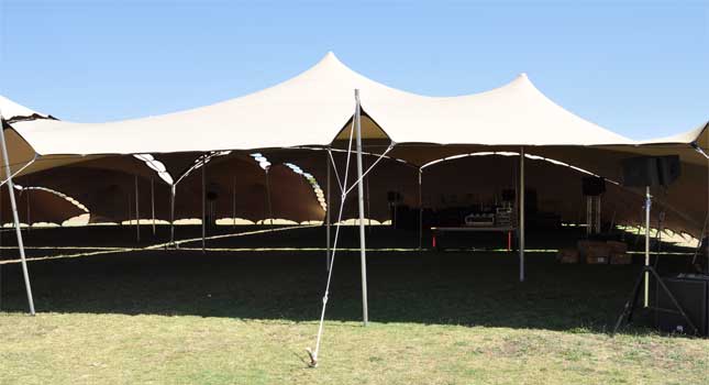 Different sized chino coloured-stretch tents linked together